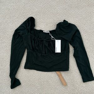 Reformation Samuel top in forest. Size medium.